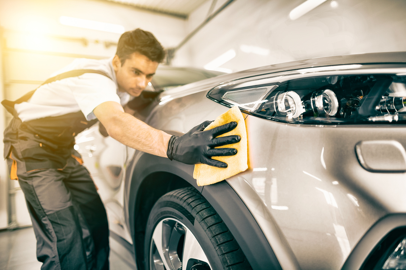 A Man Cleaning A Car